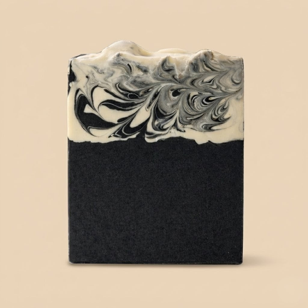 Black and white marbled soap bar on a beige background